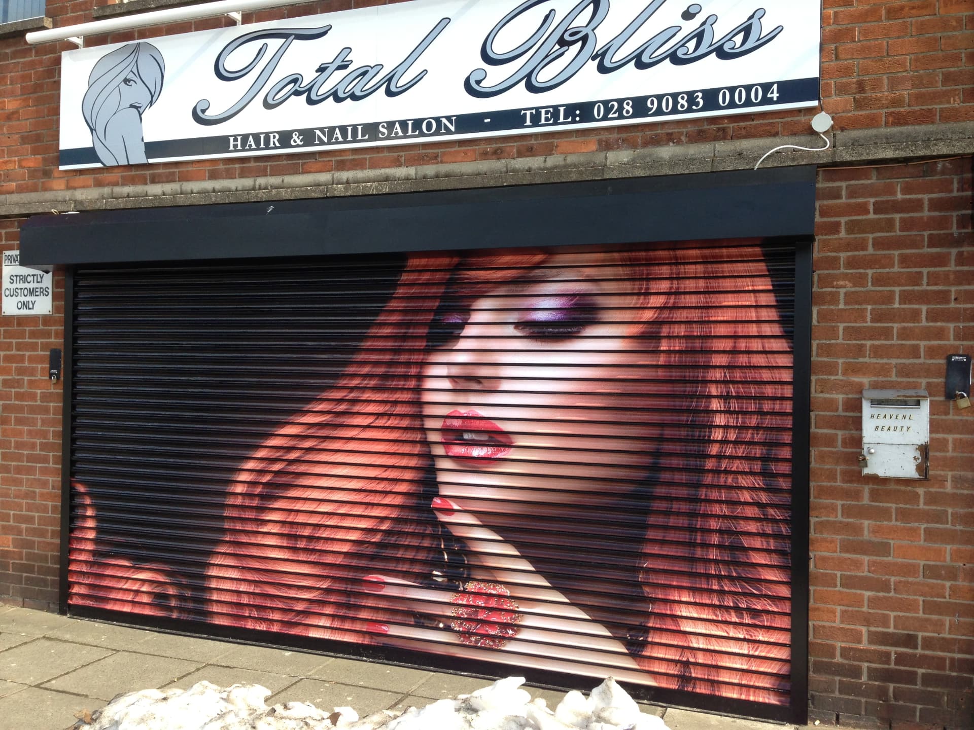 Illustrated shutter artwork covering a closed shopfront designed, printed and installed by Shutter Media in County Durham.