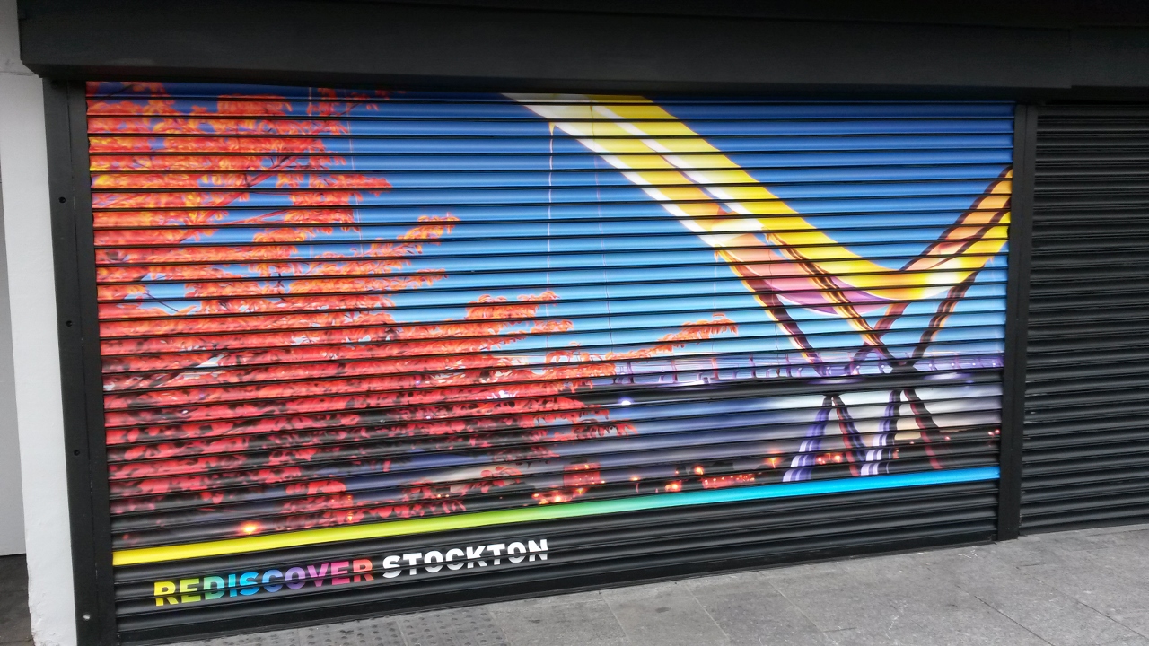 Printed roller shutter graphics on a commercial shopfront installed by Shutter Media in the North East — archive project 5.