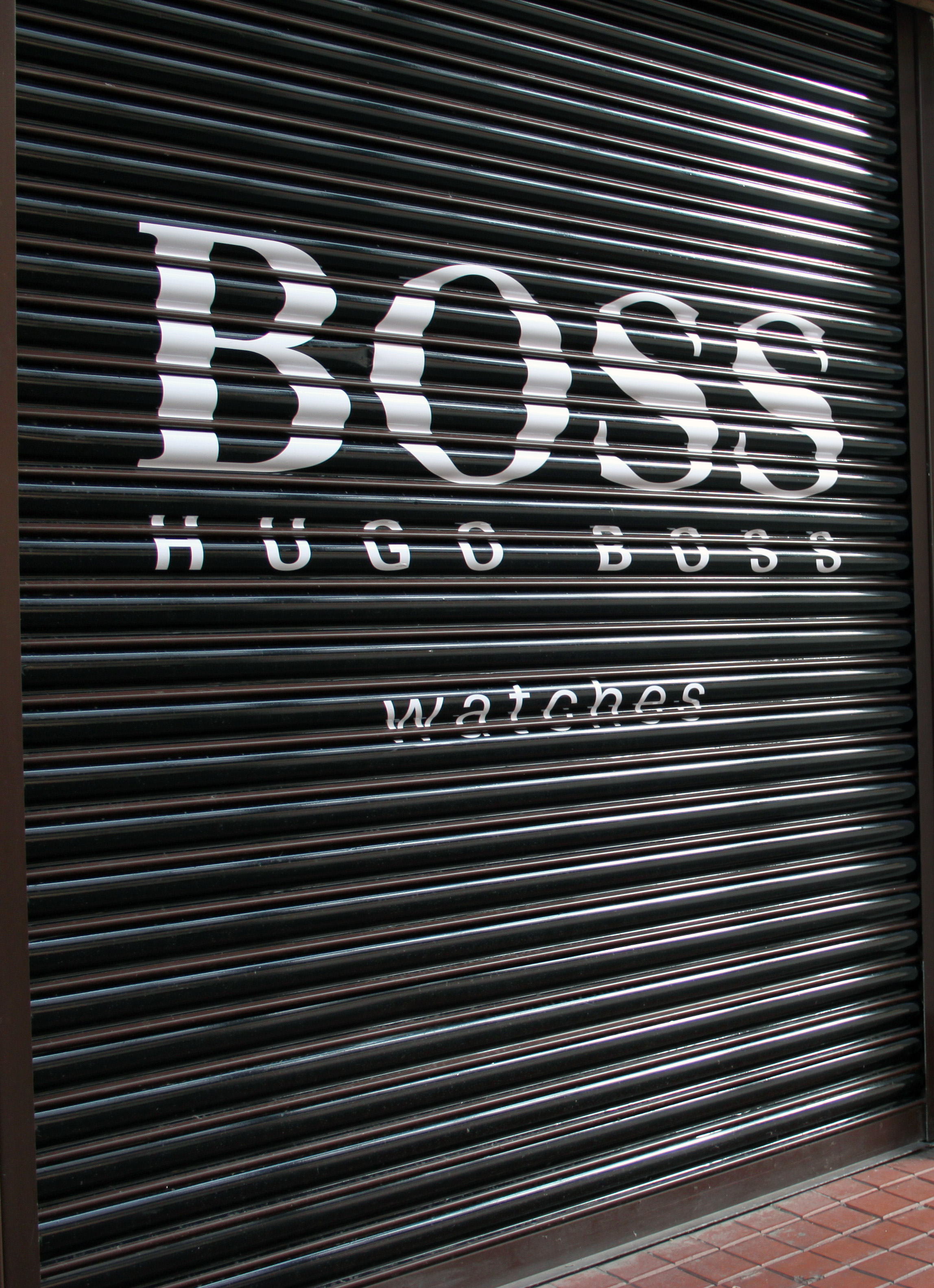 Printed roller shutter graphics on a commercial shopfront installed by Shutter Media in Newcastle upon Tyne — archive project 7.