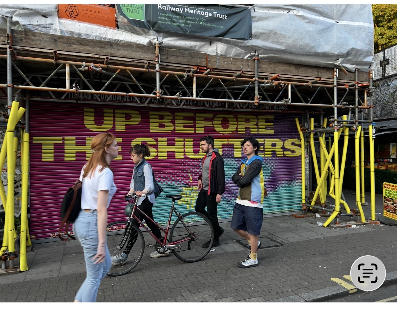 Nike Up Before the Shutters campaign visible at street level with pedestrians passing