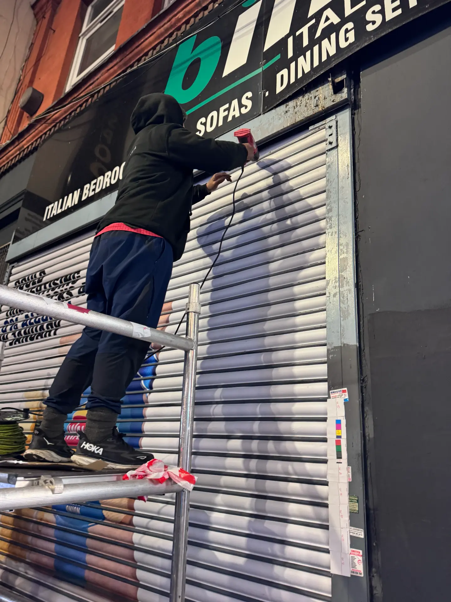 Illustrated shutter artwork covering a closed shopfront designed, printed and installed by Shutter Media in County Durham.