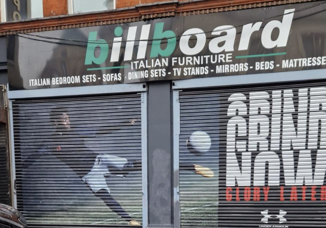 Shopfront graphics wrapping shutter, fascia and window designed, printed and installed by Shutter Media in the UK.