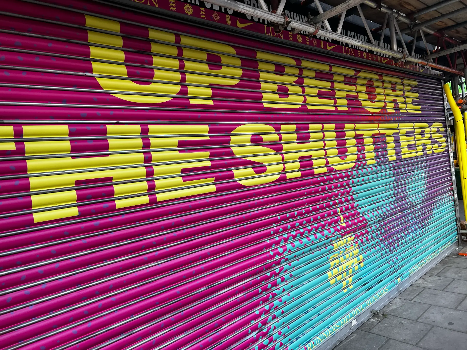Shopfront graphics wrapping shutter, fascia and window designed, printed and installed by Shutter Media in the UK.