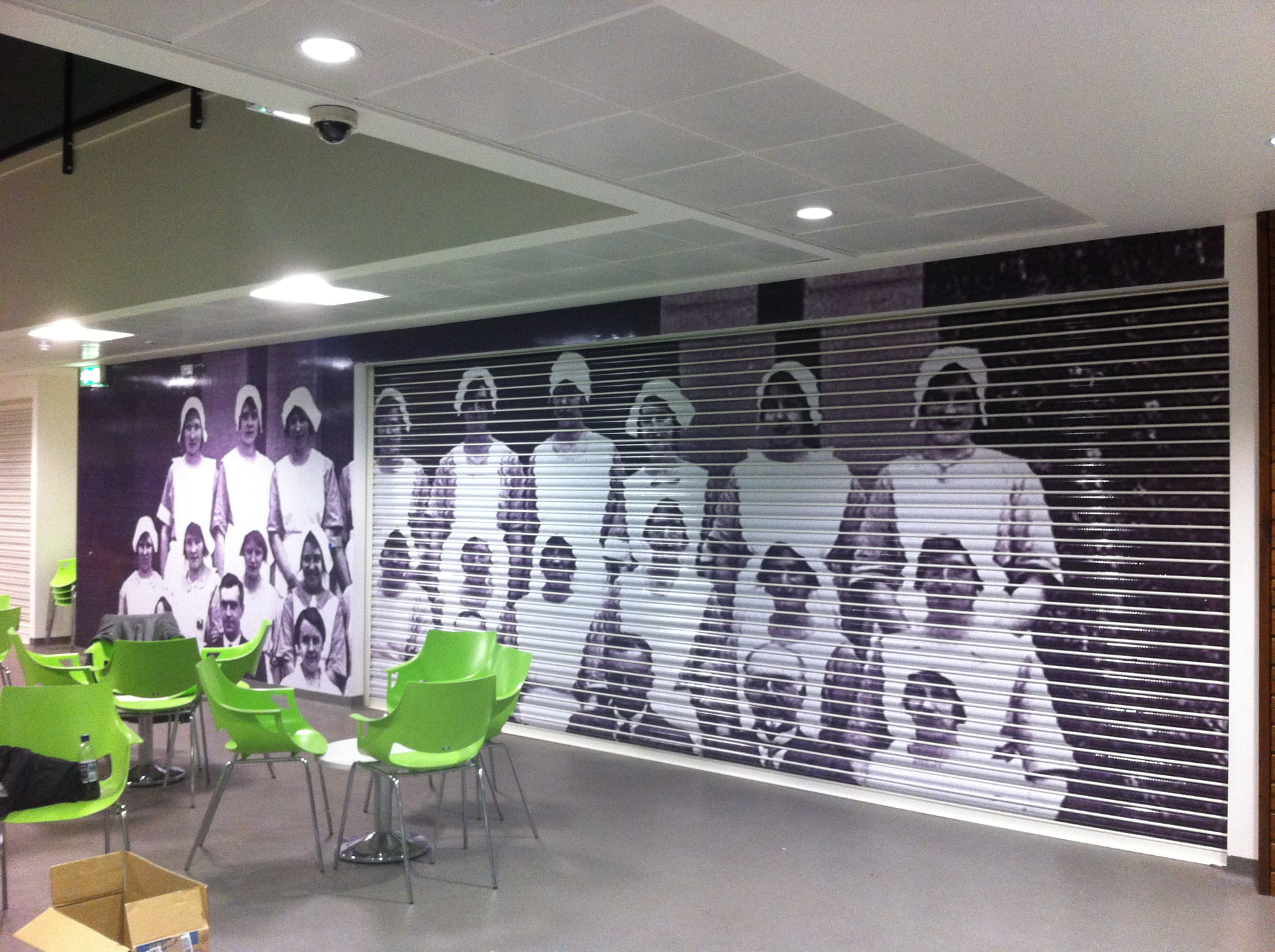Shopfront graphics wrapping shutter, fascia and window designed, printed and installed by Shutter Media in the UK.