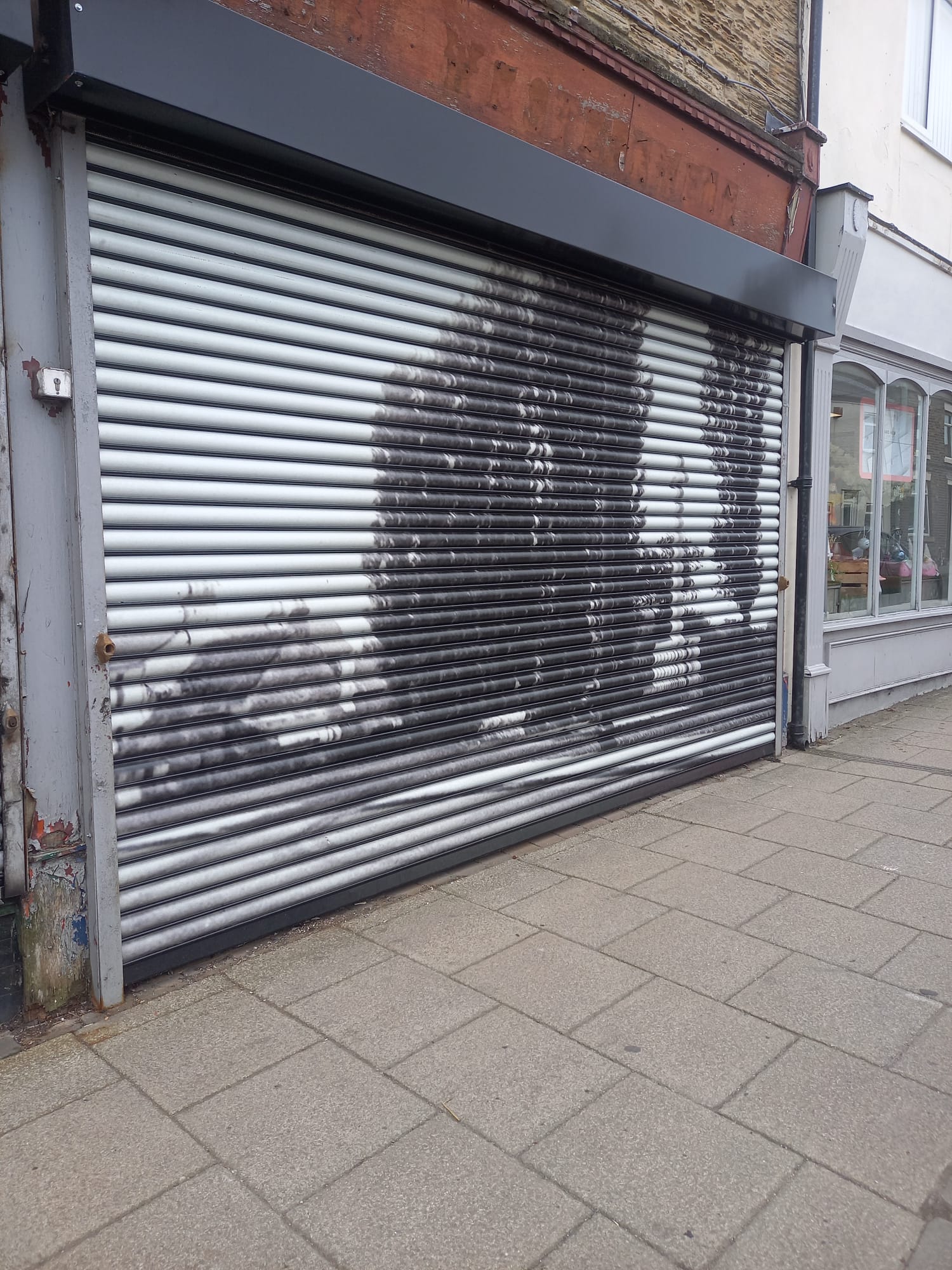 Full-colour shutter wrap on a high street shop designed, printed and installed by Shutter Media in Stockton-on-Tees.
